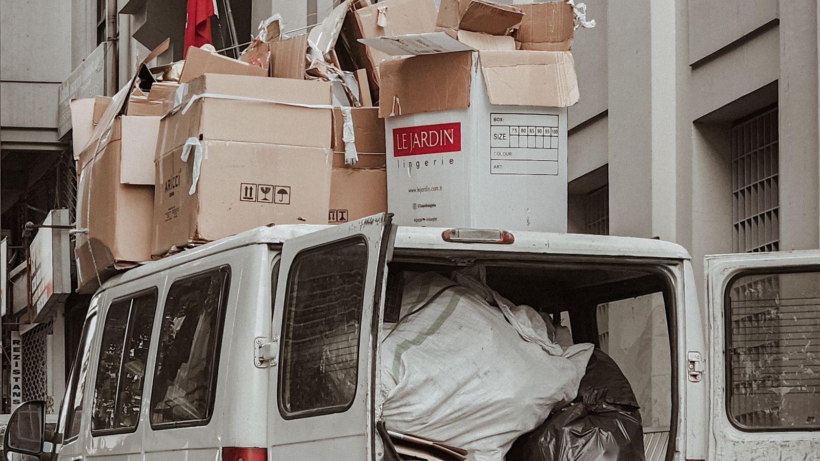 Van loaded with boxes in a narrow alleyway