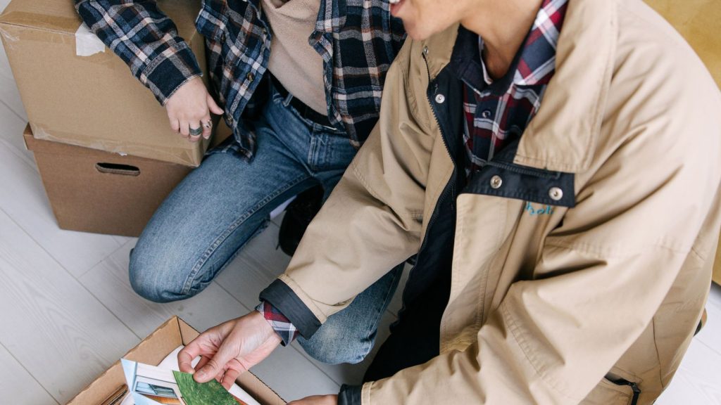 Couple looking at old photographs found in a storage box
